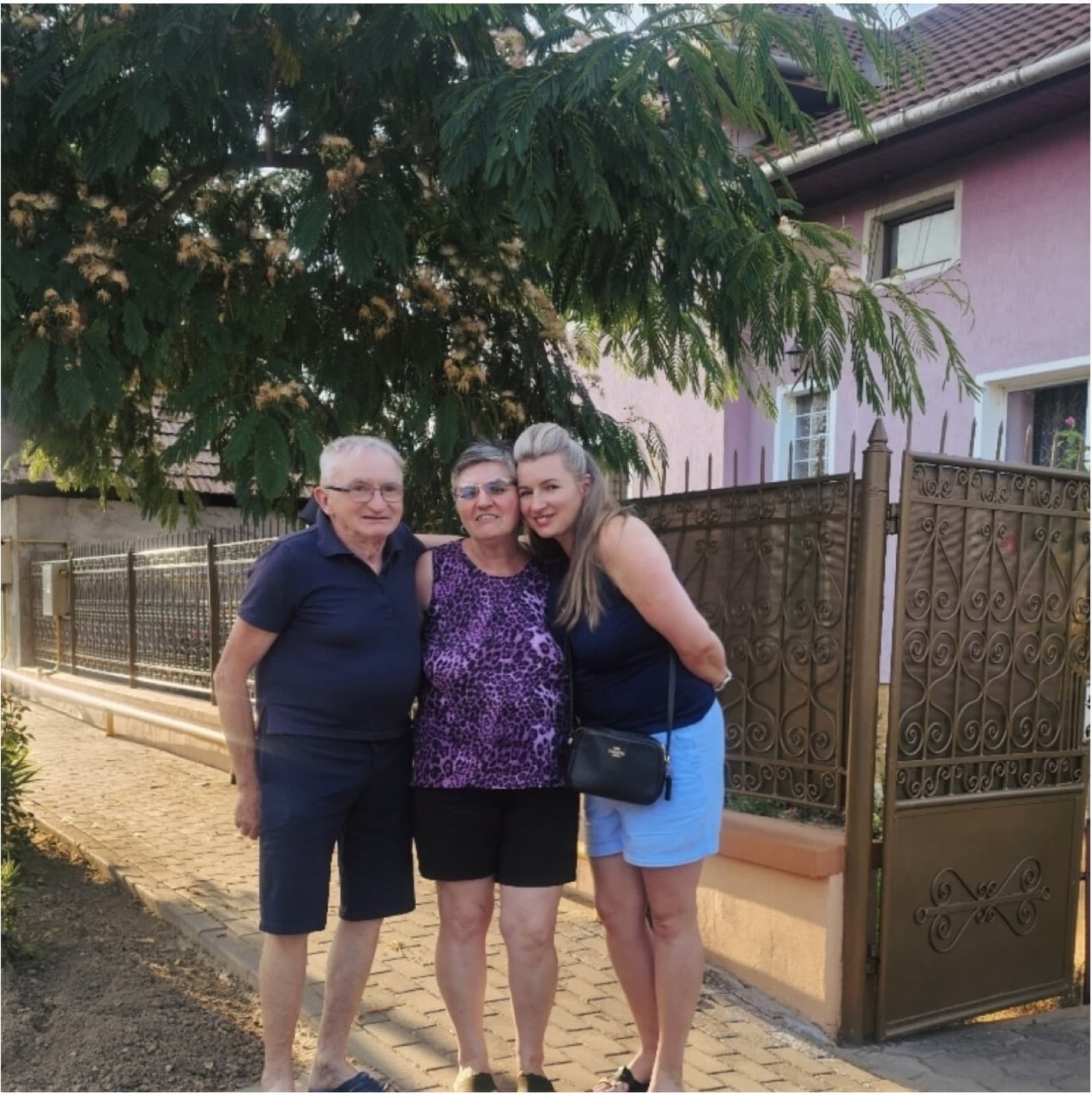 Dani with her parents outside their home in Orăștie
