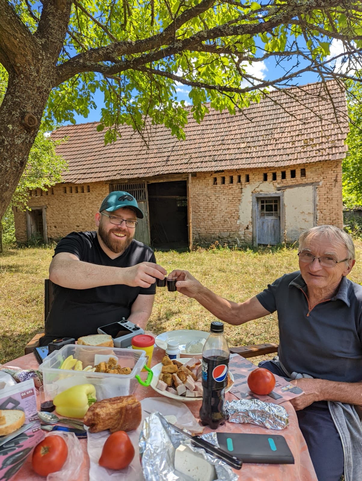 Darragh sharing a toast of țuică with Dani's father in Romania