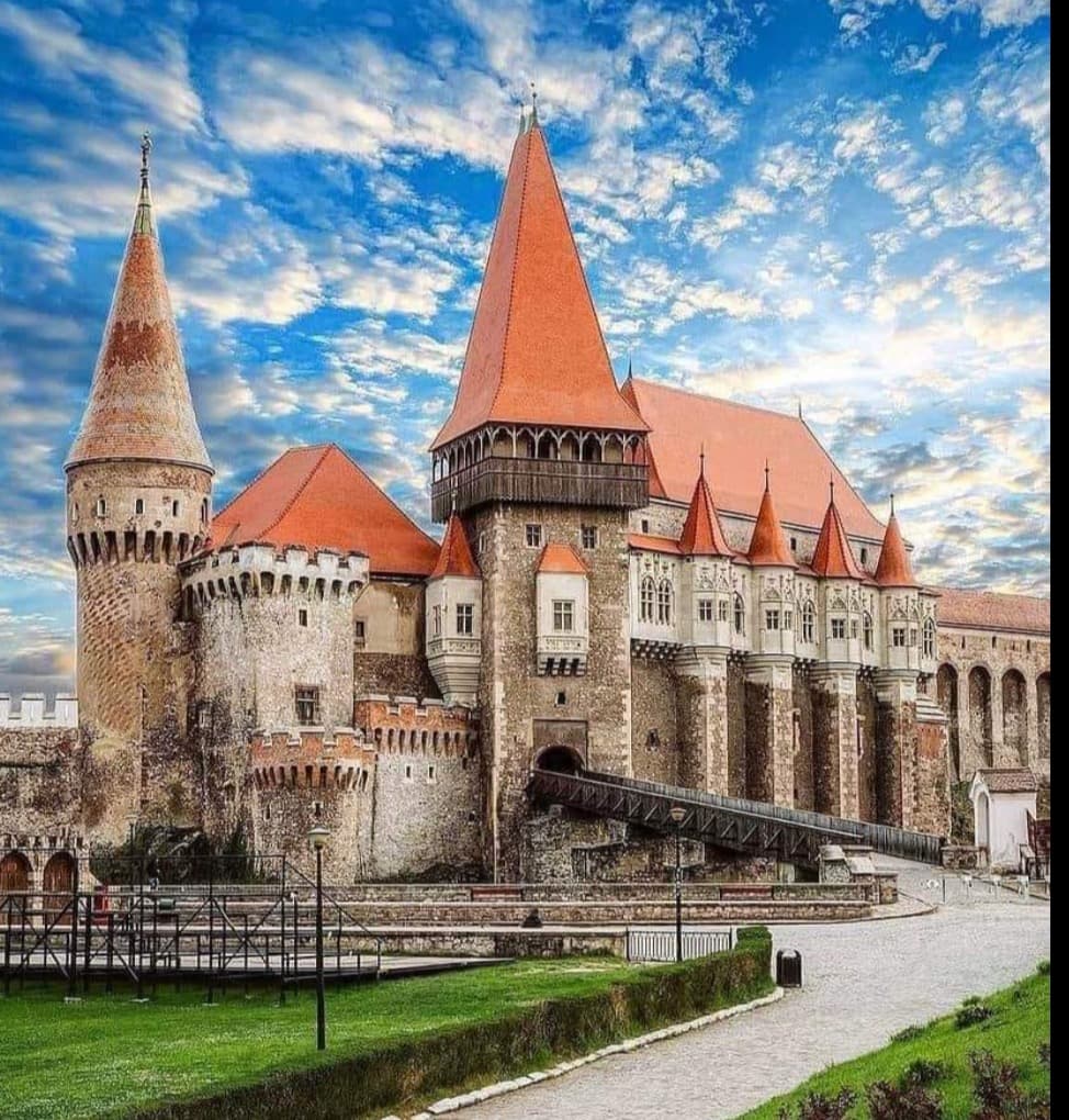 Corvin Castle's towers and turrets under a bright blue sky, Hunedoara