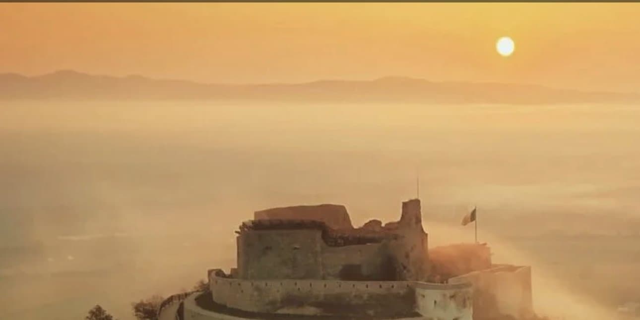 Deva's hilltop citadel rising above the morning mist at sunrise