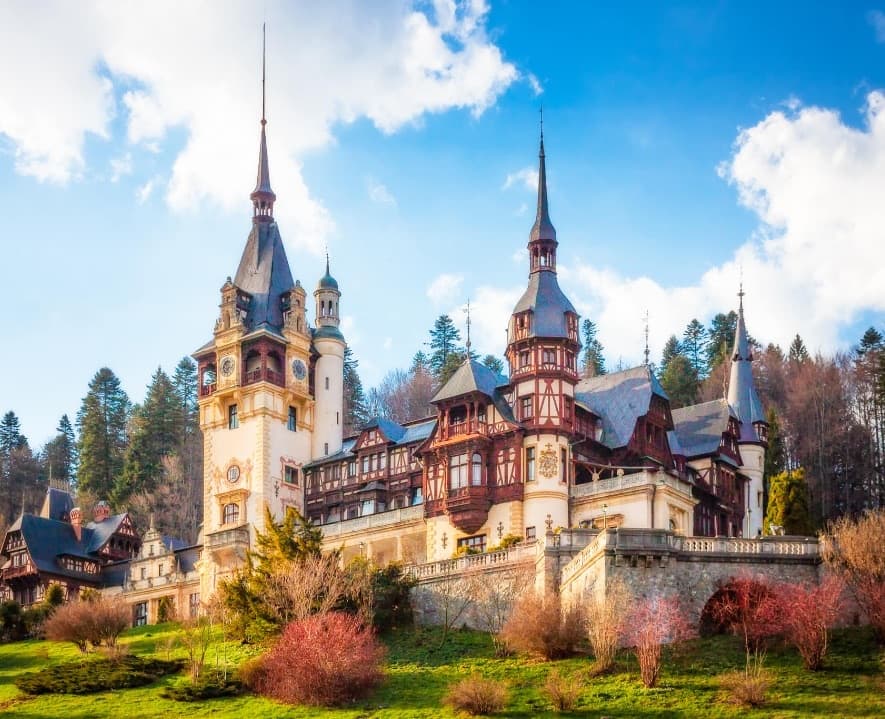 Peleș Castle's spires and half-timbered facades above its terraced gardens, Sinaia