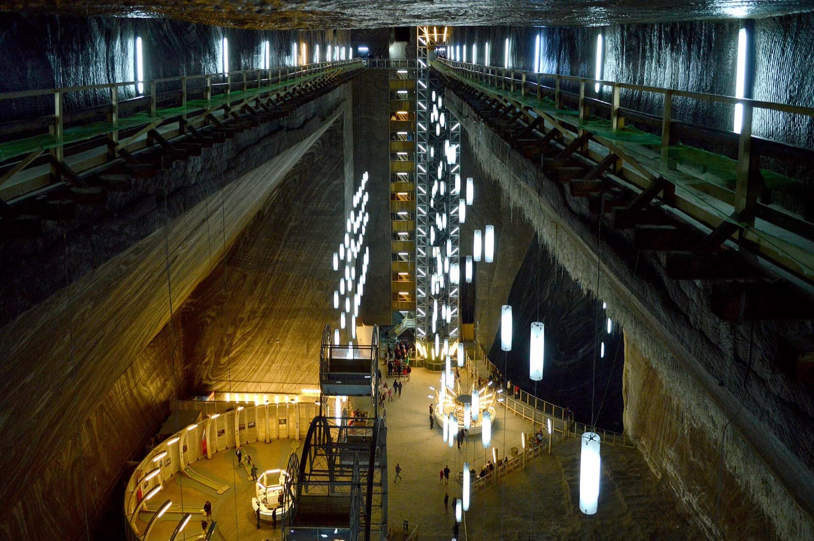 The illuminated underground amphitheatre and Ferris wheel inside the Salina Turda salt mine